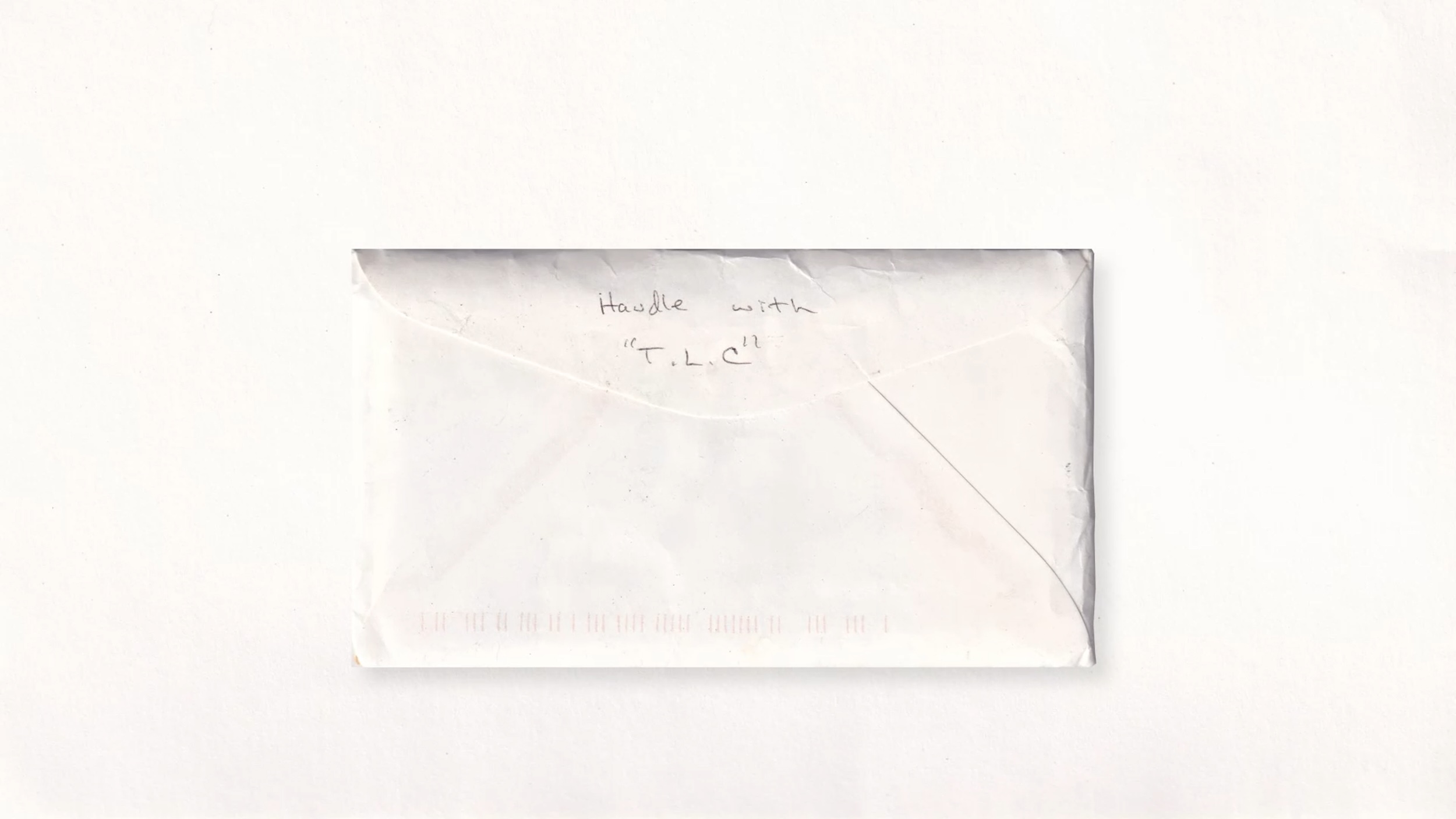 Photo of letter with 'Handle with TLC' written on it.